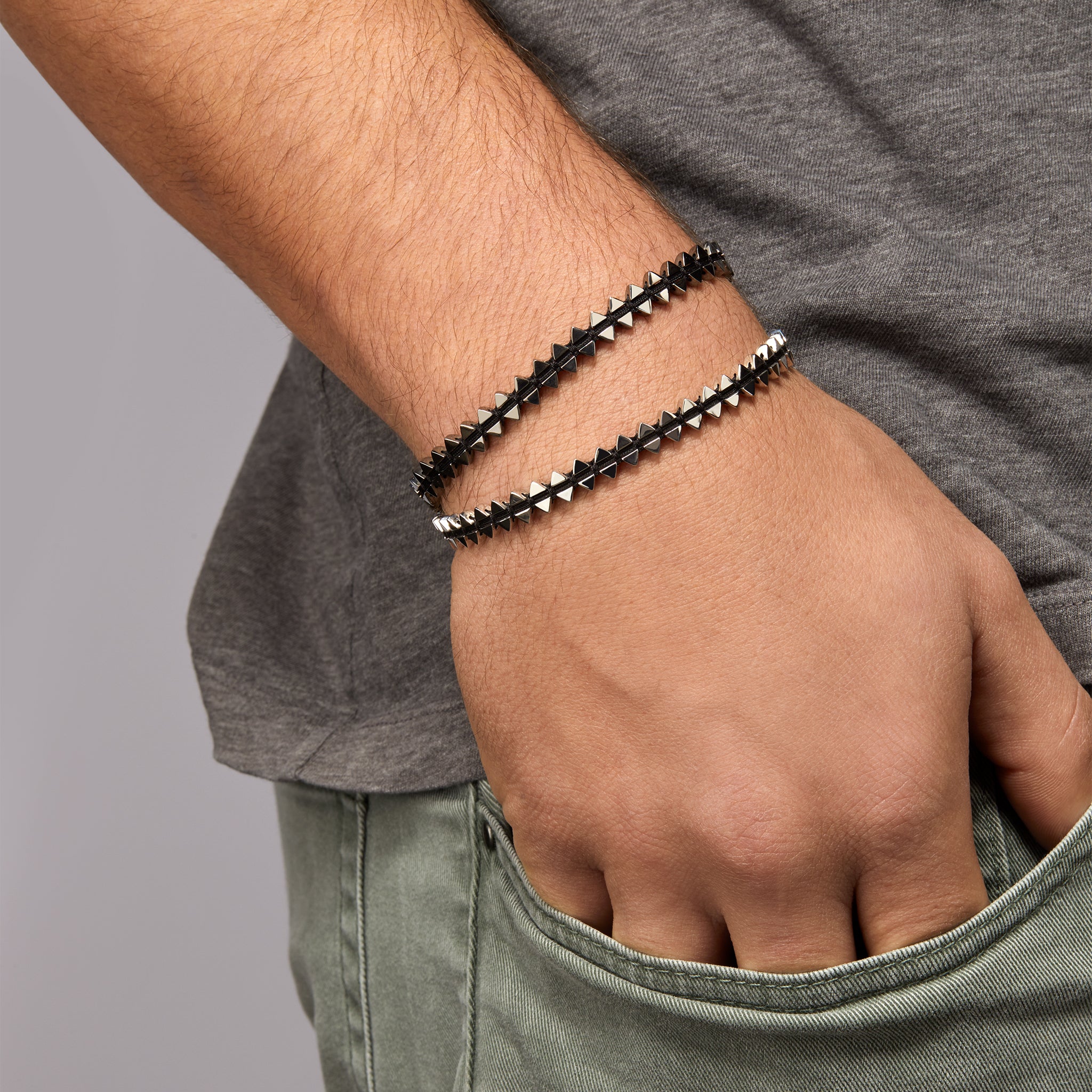 Men's dual-sided anchor bracelet with anchor and boat-inspired triangle motifs, showcased on model. 