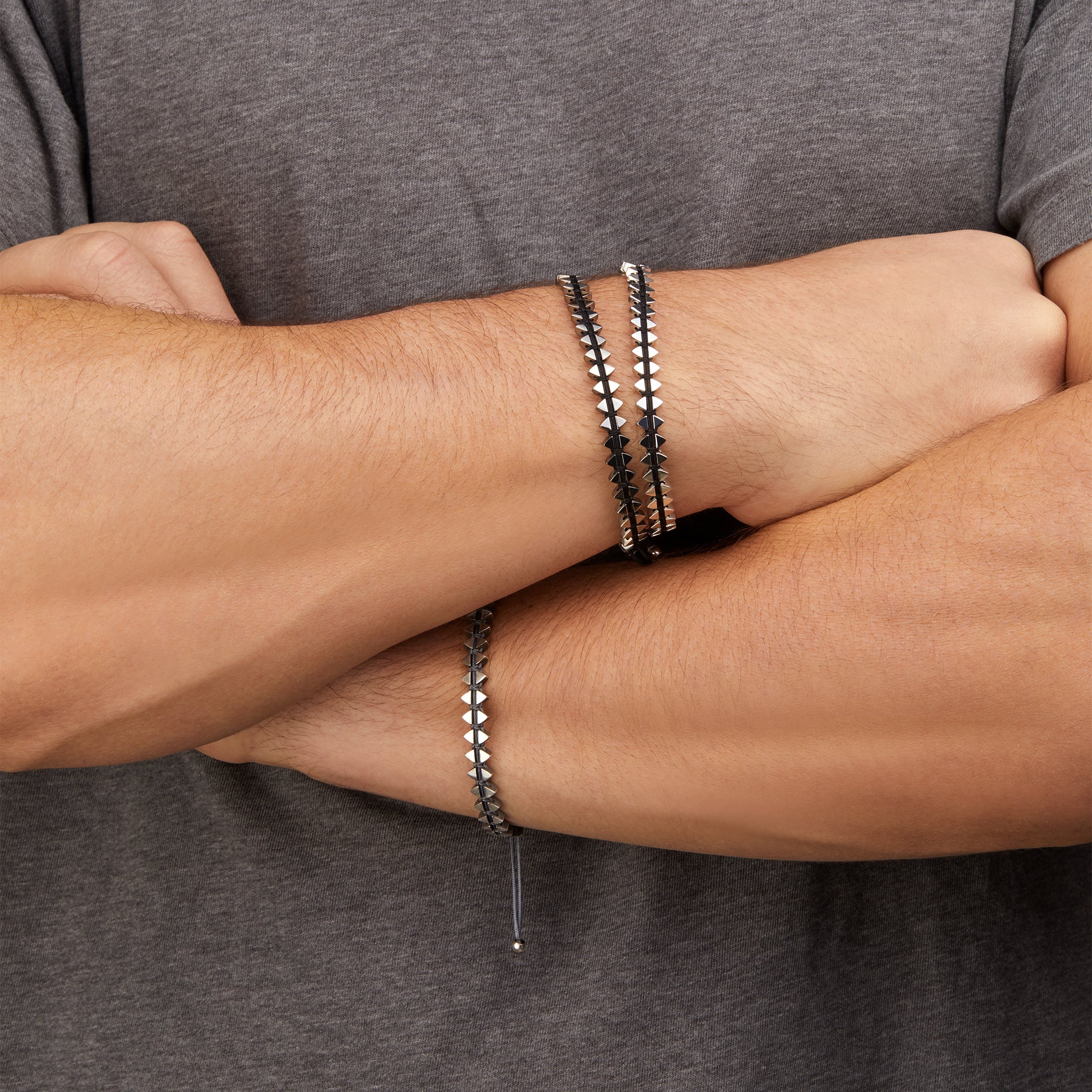 Men's dual-sided anchor bracelet with anchor and boat-inspired triangle motifs, showcased on model. 