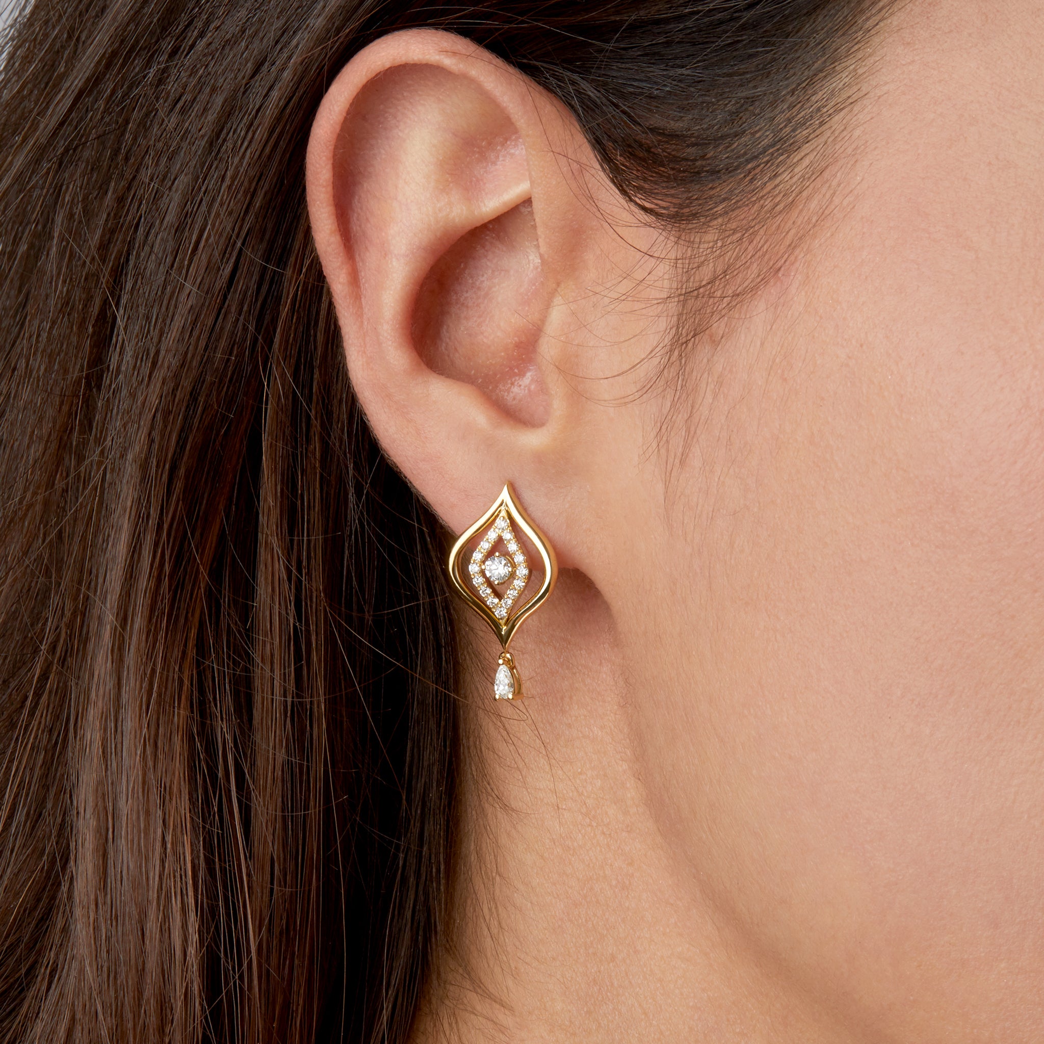 Evil Eye Diamond Earrings in yellow gold portrayed on model. 