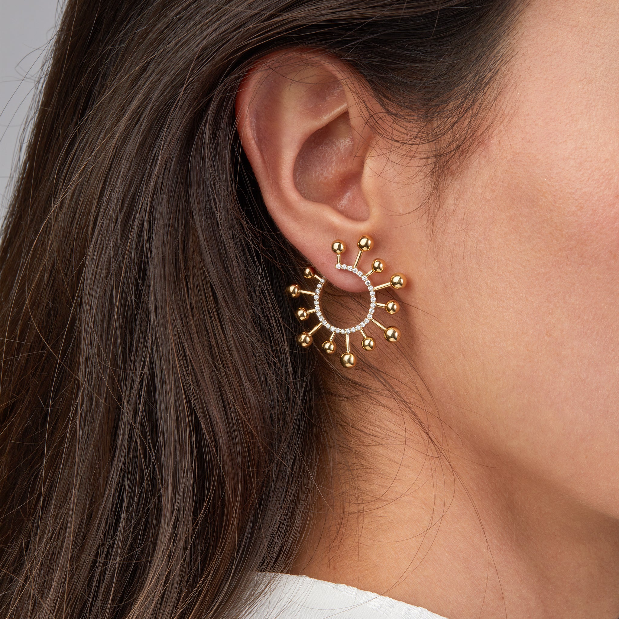 Yellow Gold Helios earrings portrayed on model.