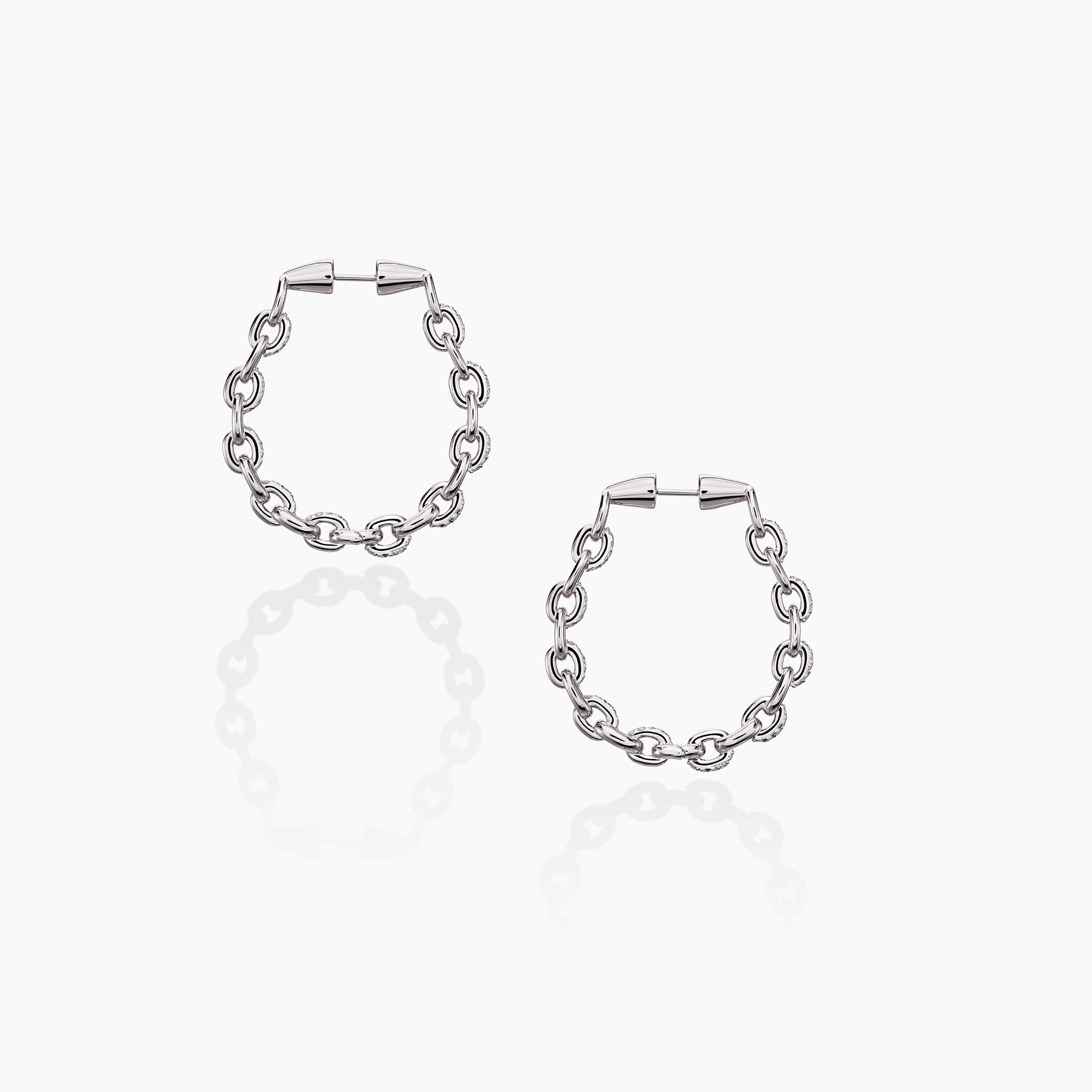 Horsebit Diamond link Hoop Earrings in yellow gold displayed on an off white background.