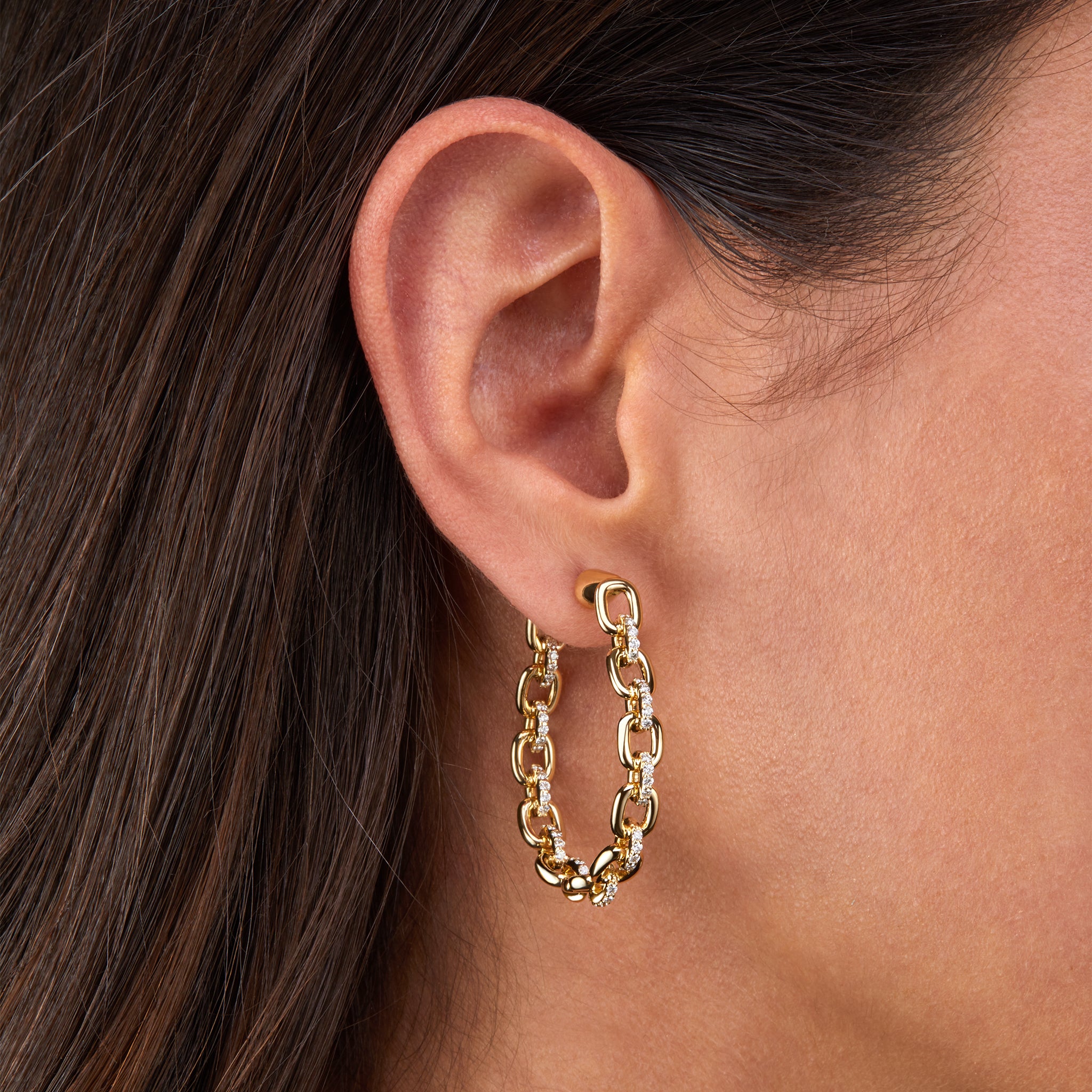 Horsebit Diamond link Hoop Earrings in yellow gold displayed on model