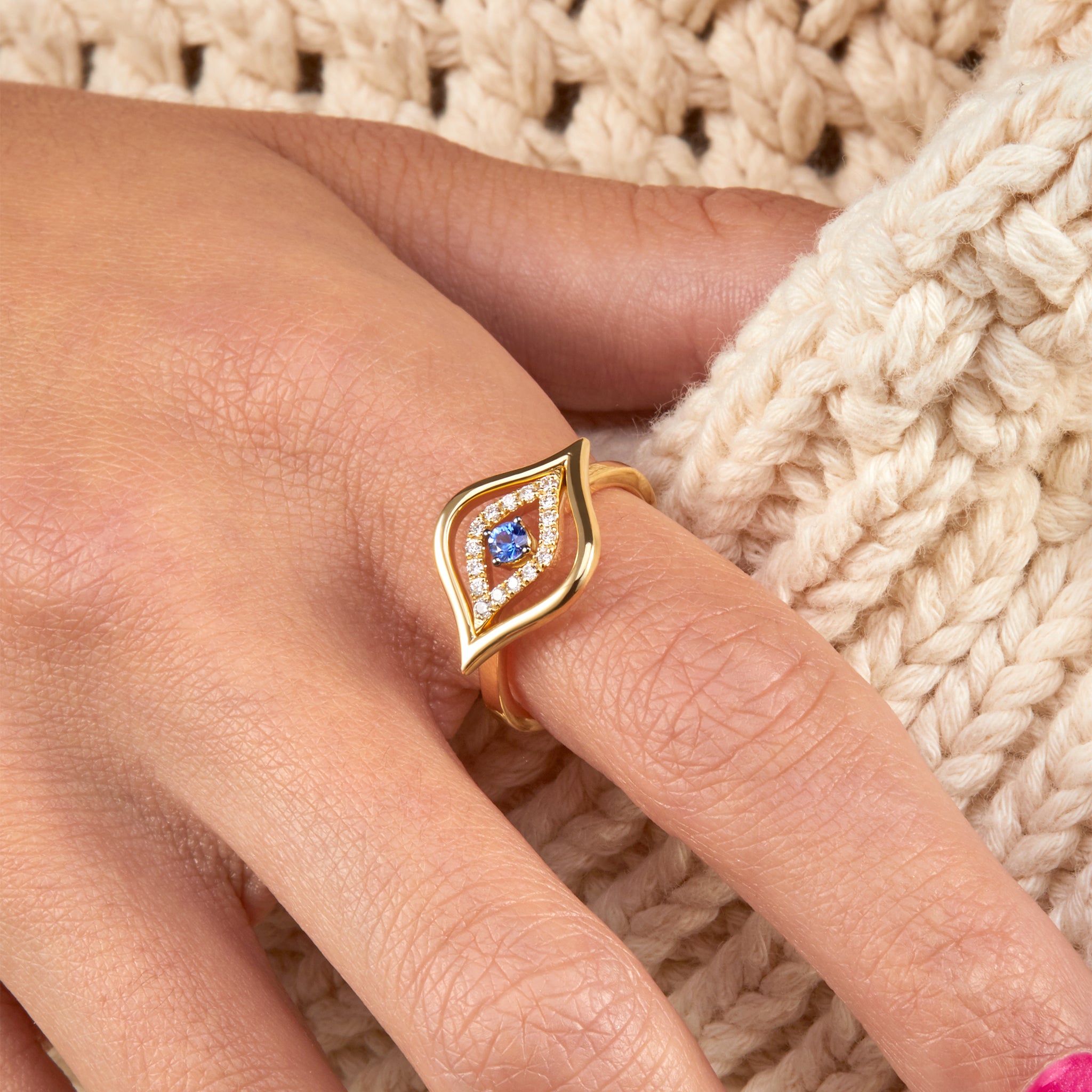 A stunning diamond and sapphire ring, presented on hand model