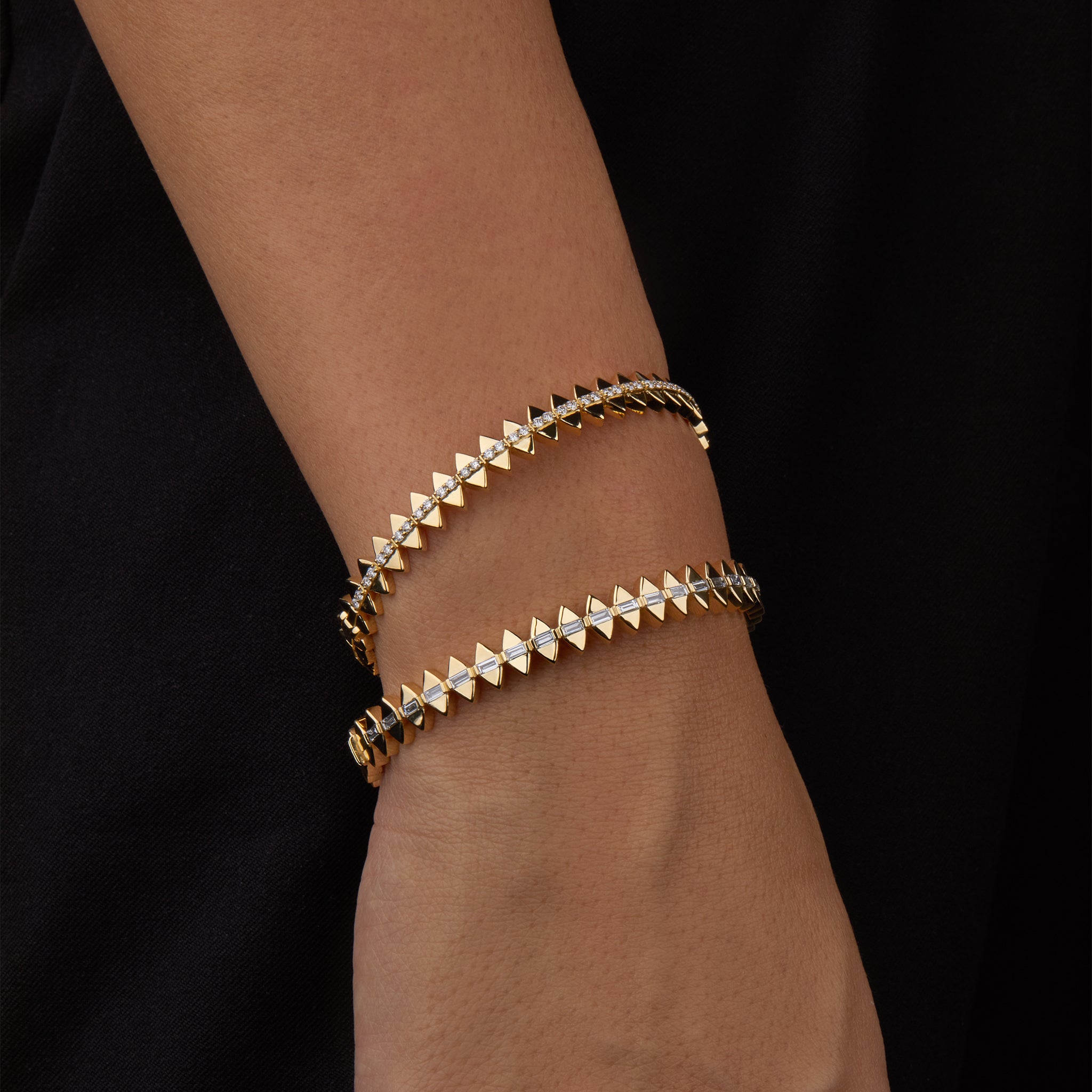 Two solidarity bangles portrayed on hand model.