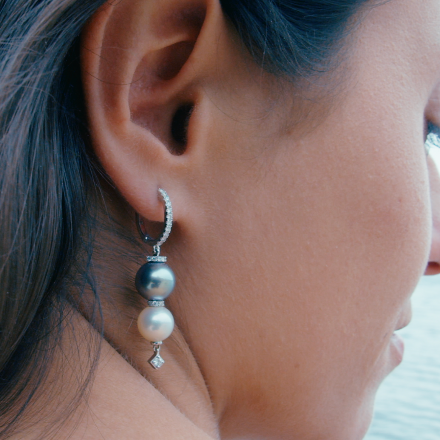 Pearl earrings displayed on model 